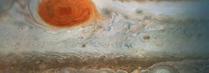 Jupiter's Great Red Spot is at top left of this image taken by NASA's Juno spacecraft. Many smaller storms are visible as well.